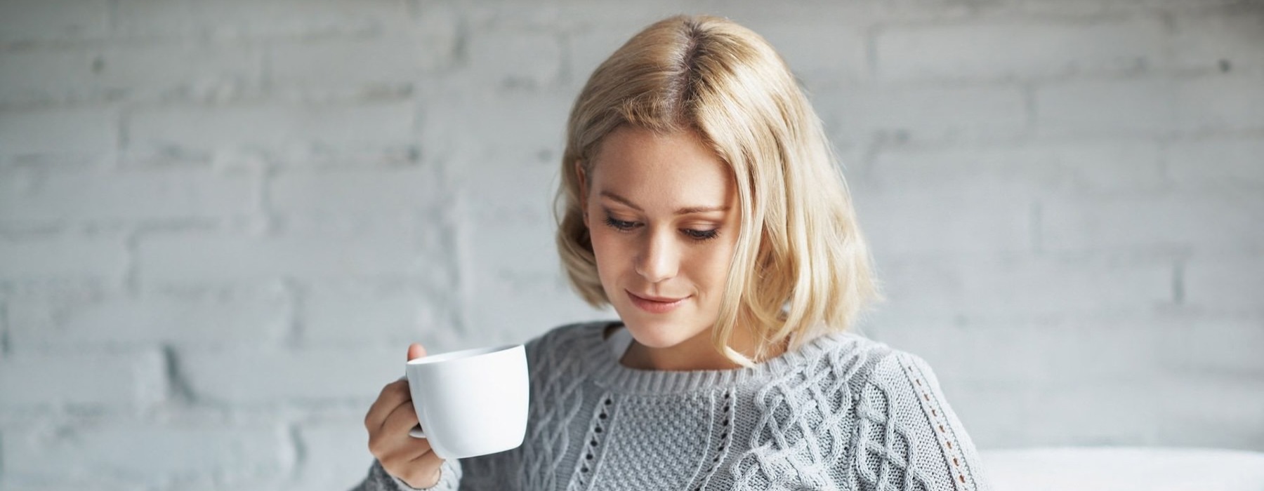 a young woman drinking coffee