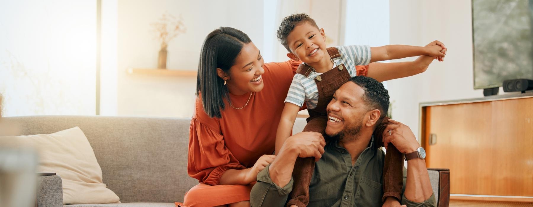 a man and woman play with their son
