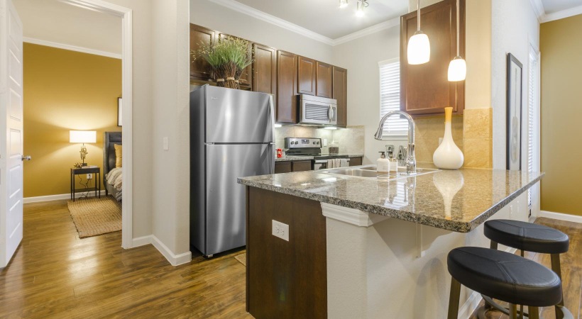pendant lighting over kitchen counter with stools