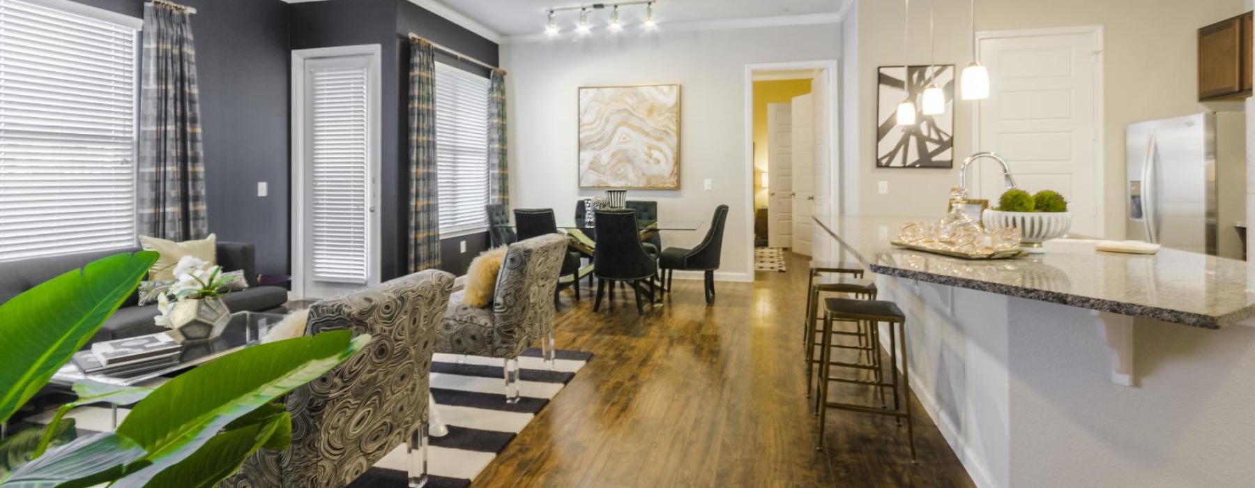 a kitchen with a bar and chairs