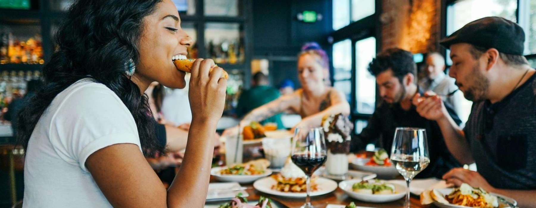 a group of people eating at a restaurant