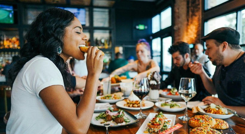 a group of people eating at a restaurant