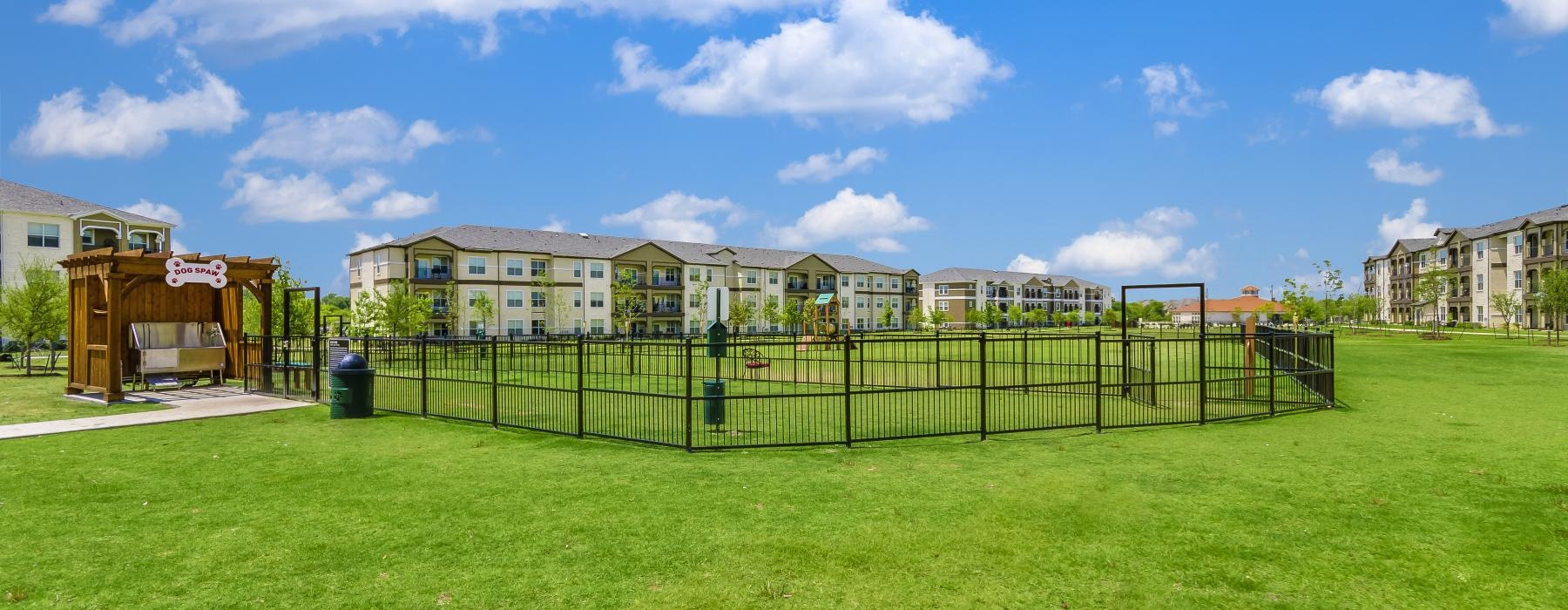 fenced dog park in a field